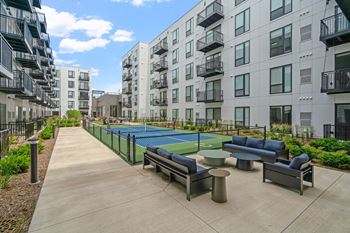 an apartment building with a tennis court and a ping pong table